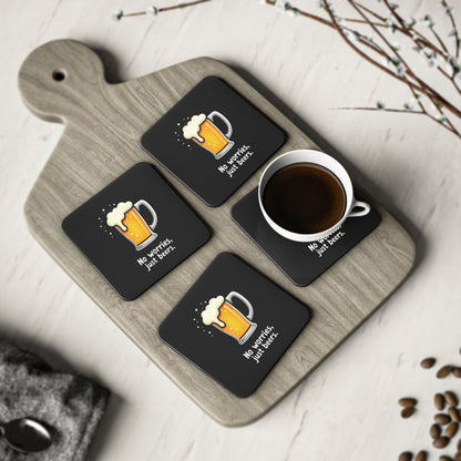 Set of 4 black No Worries Just Beers coasters with beer mug print, displayed on a wooden board with a coffee cup