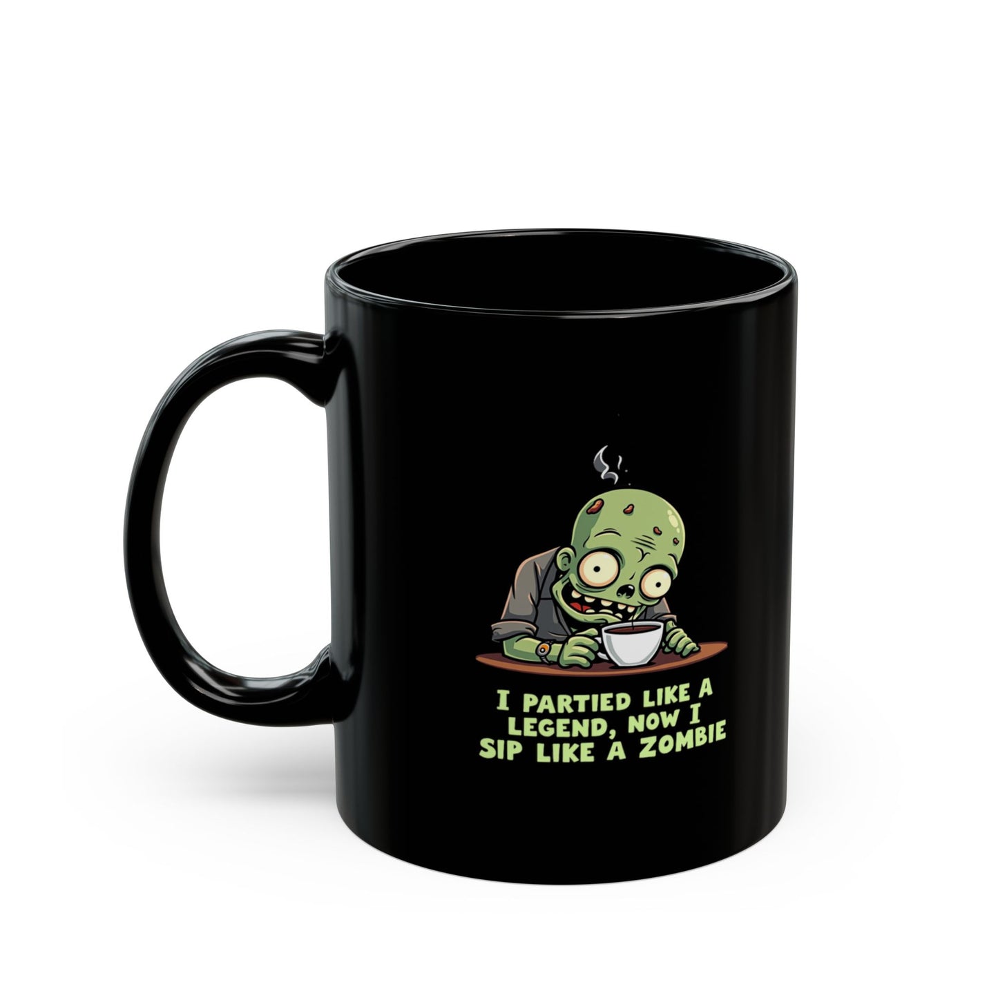 Black coffee mug with cartoon zombie clutching a cuppa, text reads I Partied Like A Legend Now I Sip Like A Zombie