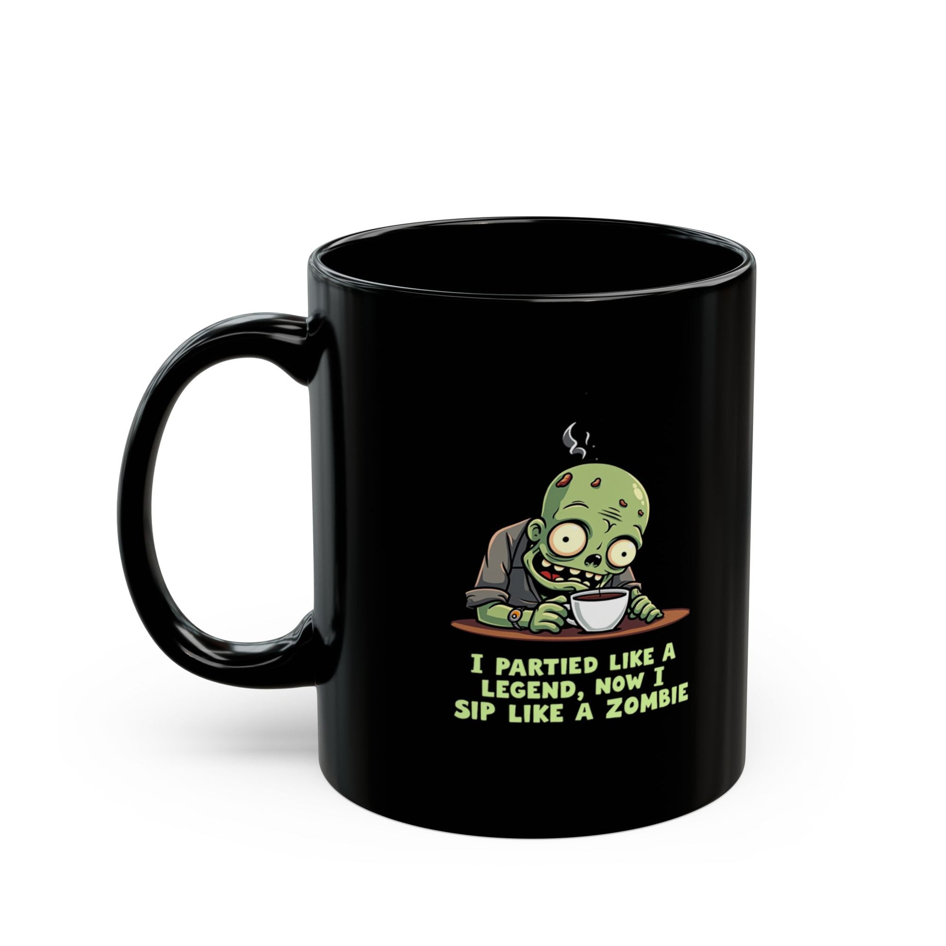 Black coffee mug with cartoon zombie clutching a cuppa, text reads I Partied Like A Legend Now I Sip Like A Zombie