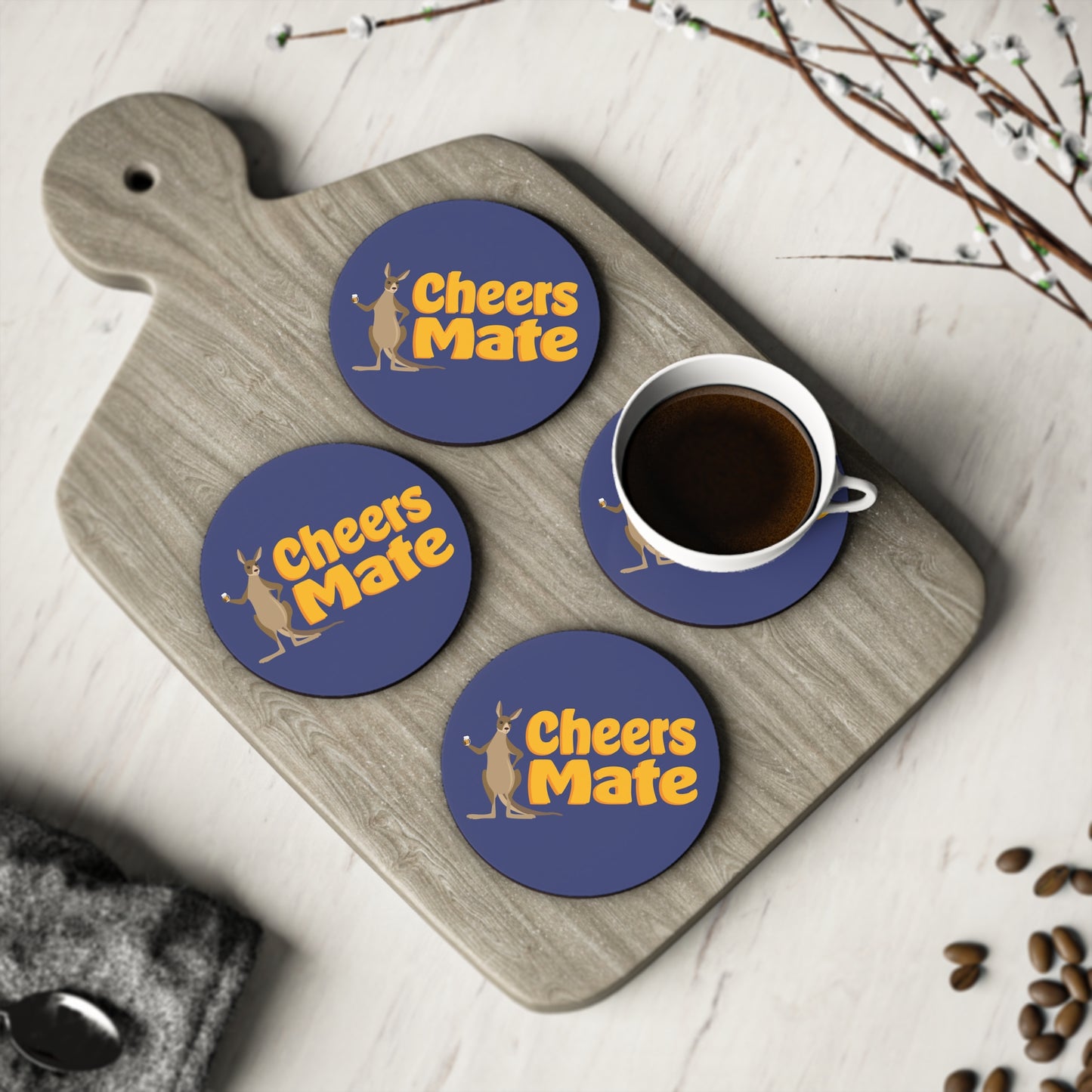 Cheers Mate Coasters set of four, navy blue round coasters with gold kangaroo design on timber board