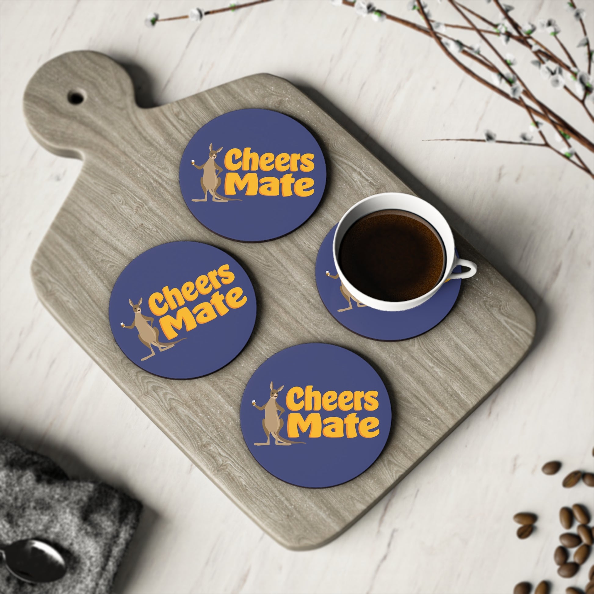 Cheers Mate Coasters set of four, navy blue round coasters with gold kangaroo design on timber board