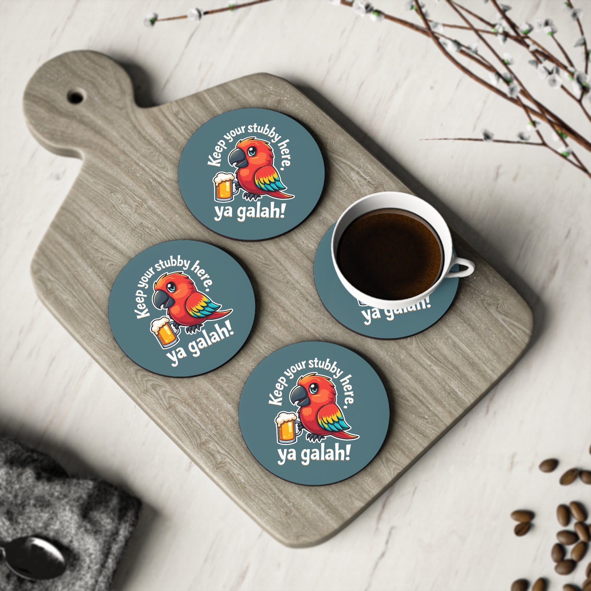 Set of 4 round teal coasters with cartoon galah holding beer, "Keep your stubby here, ya galah!" on timber board