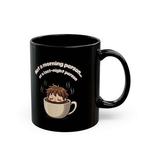 Black coffee mug with cute sleeping cartoon in a cup and 'Not a morning person' text. Funny gift for tired mates.
