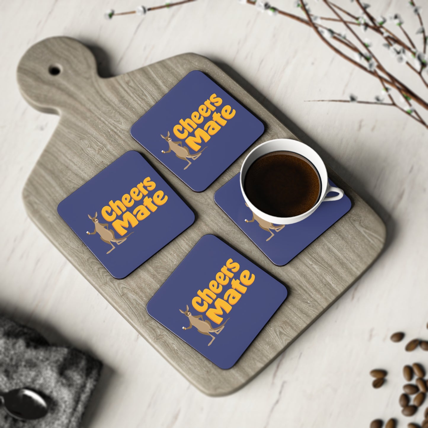 Cheers Mate Coasters set of four, navy blue with gold kangaroo design, styled with a coffee cup on a timber board