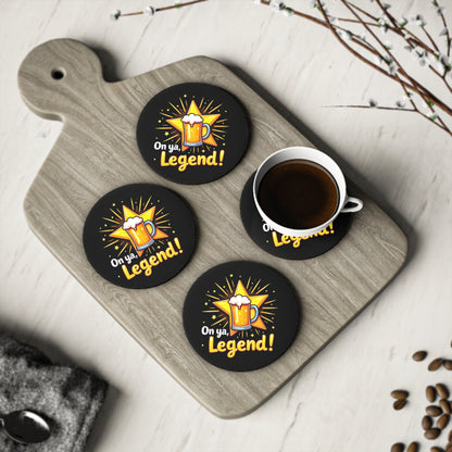 Set of 4 round black coasters with 'On ya, Legend!' beer mug design on timber serving board